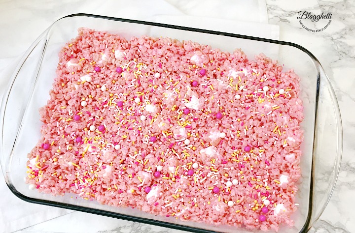 baking dish with pink lemonade rice krispie treats cooling