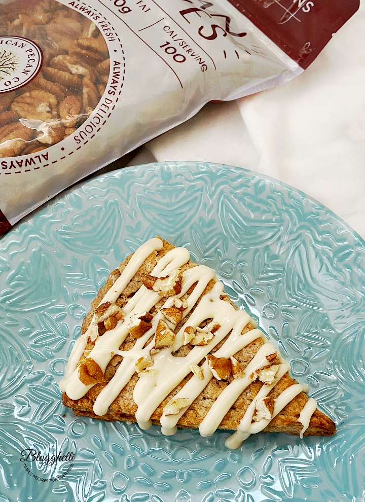 carrot cake scone with icing on blue plate