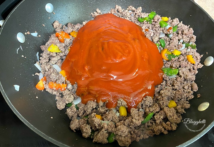 ground beef with sloppy joe sauce simmering