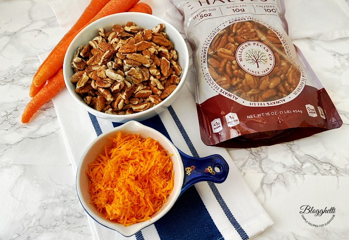 shredded carrots and chopped pecans in bowls
