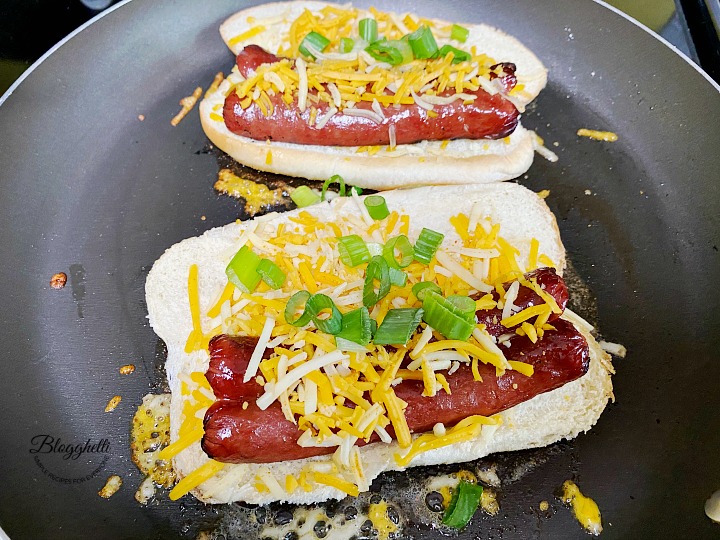 cooking the grilled cheese hot dogs in skillet