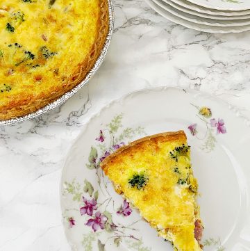slice of Broccoli and Ham quiche on flowered china plate
