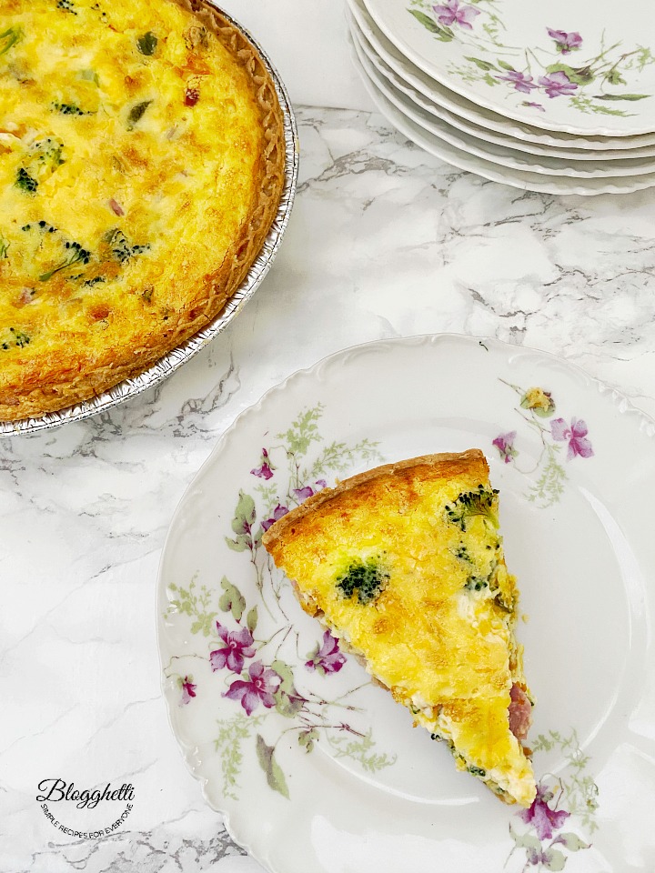 slice of Broccoli and Ham quiche on flowered china plate