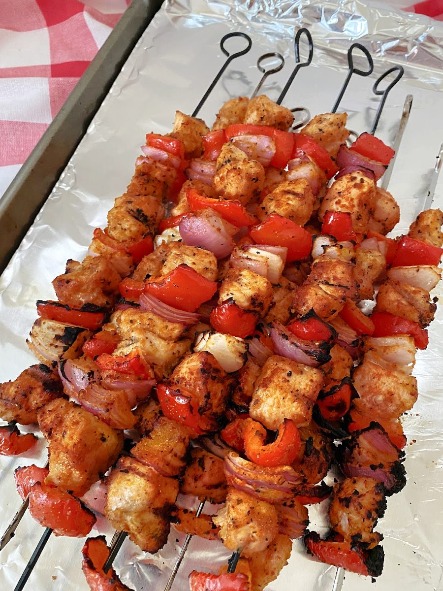 overhead view of chicken and vegetable kabobs on tray