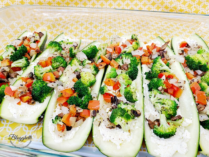 layering the vegetables in zucchini boats