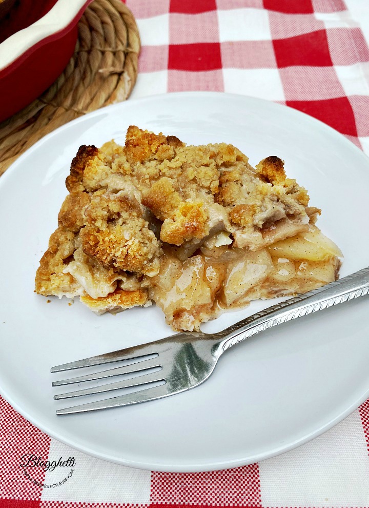 Amish pear crumb pie slice on white plate with fork