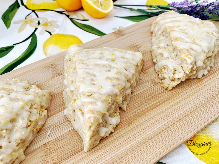 close up of lemon lavender scones with glazed on wooden board