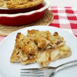 slice of Amish Pear Crumb Pie on white plate with fork