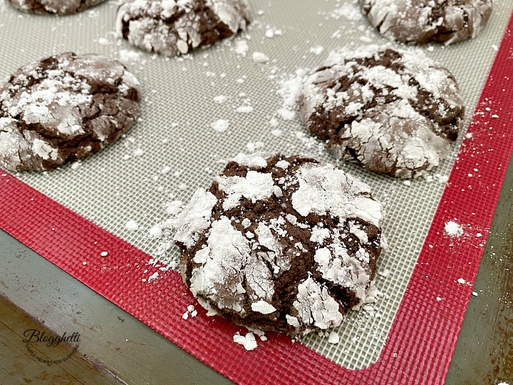 close up of Chocolate crinkle cake mix cookies on baking sheet