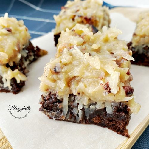 square bites of German chocolate brownies on wooden board