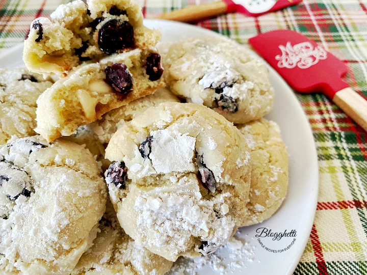 close up of white chocolate cranberry crinkle cookies on plate