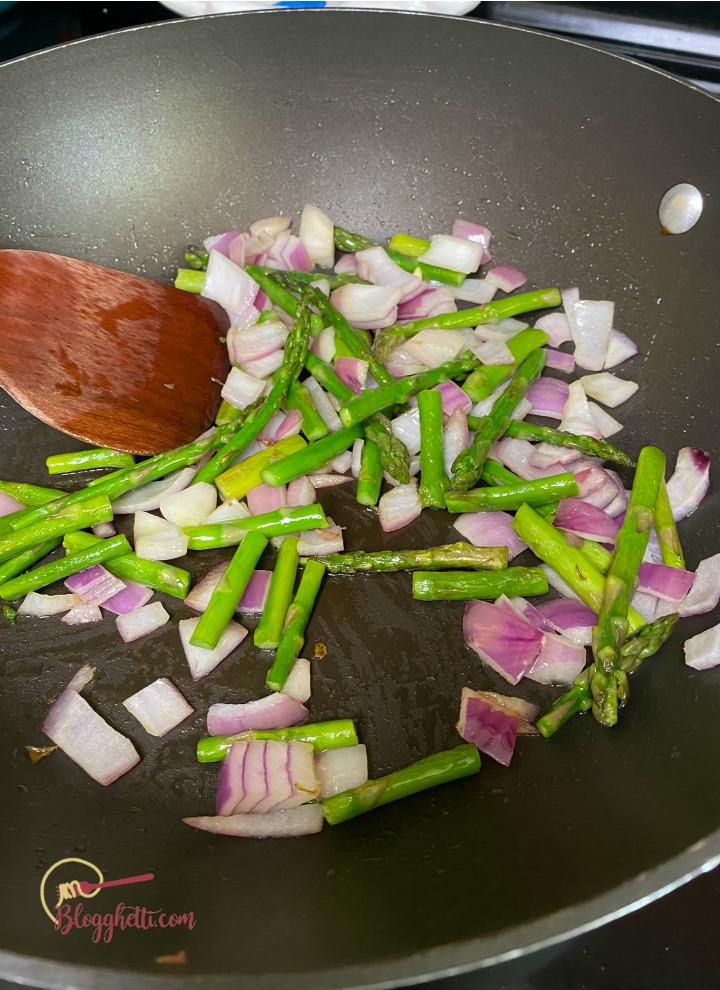 sauteing onions and asparagus in skillet