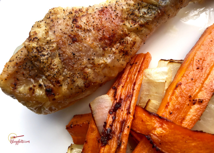 oven roasted chicken drumsticks with roasted carrots on white plate
