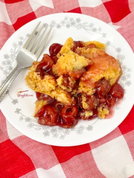 cherry cobbler served on white and gray plate