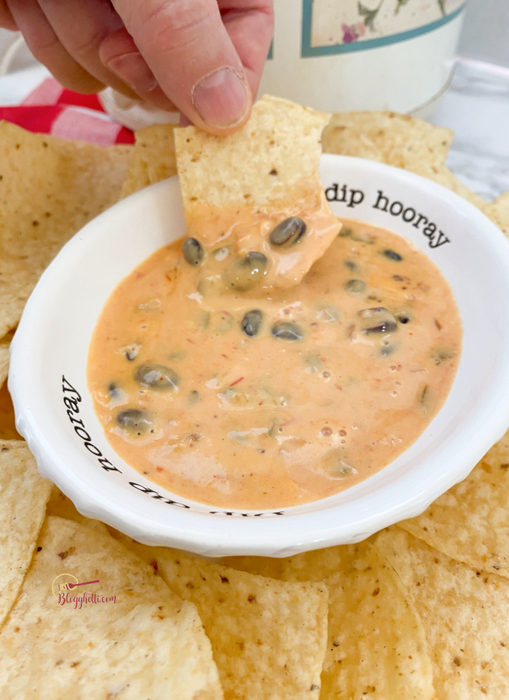 chip dipped in spicy cheese dip