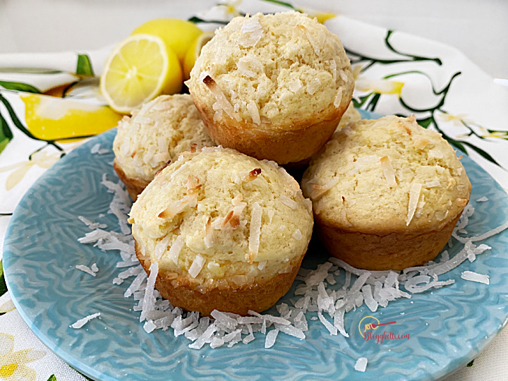 close up of lemon coconut muffins on blue plate