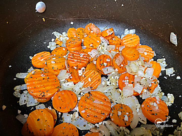 cooking onions and carrots in Dutch Oven for soup