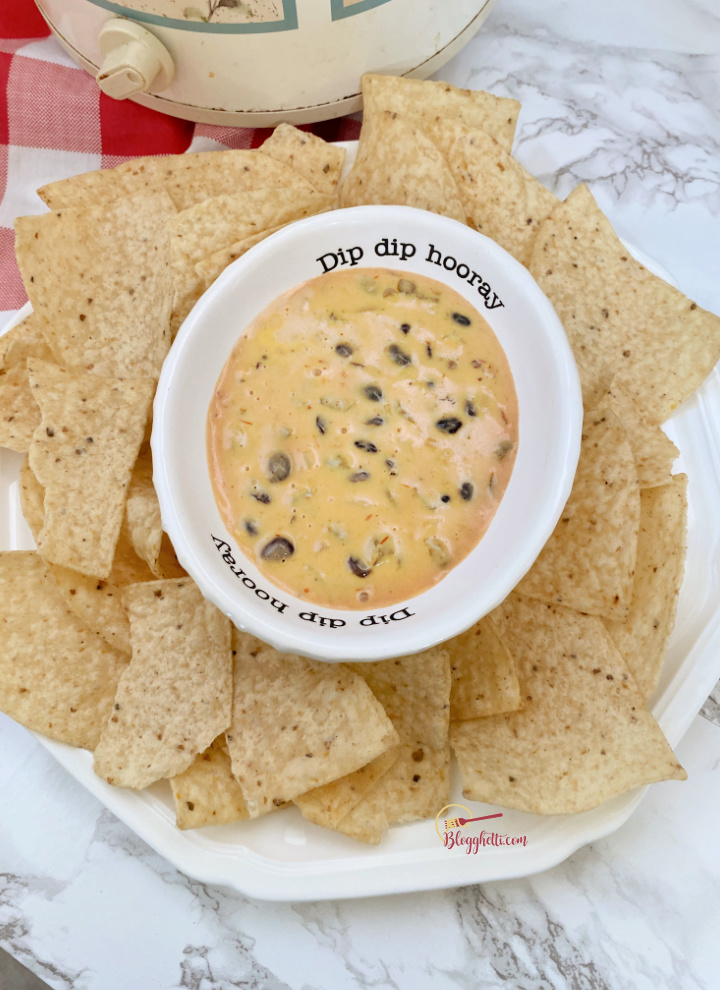 plate of chips with vegetarian spicy cheese dip in cute bowl