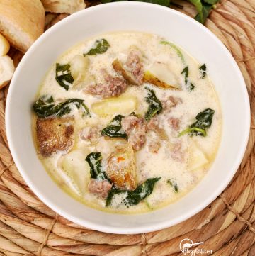zuppa toscana soup in white bowl made in the slow cooker