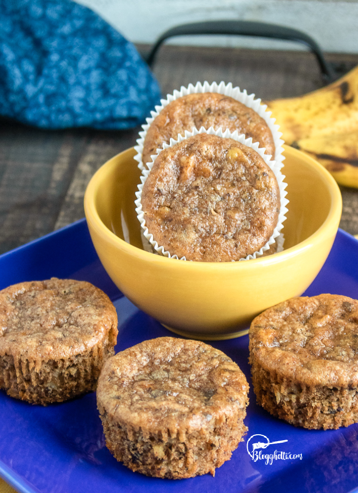 Healthy Banana Chocolate Chunk Muffins on blue plate and in yellow bowl
