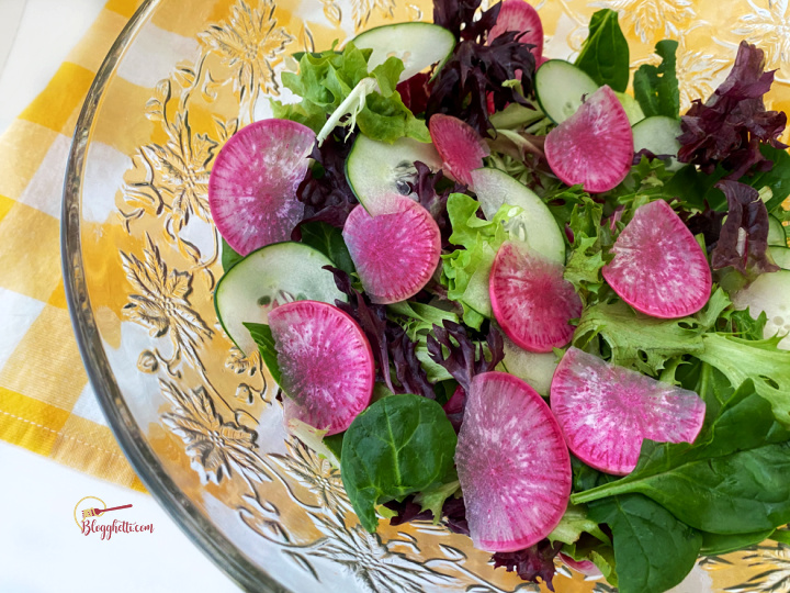 Cucumber, Purple Daikon Radish with spring greens salad in crystal bowl