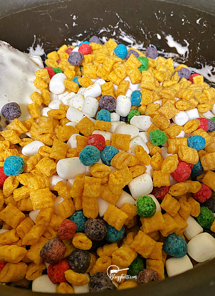 adding captain crunch cereal to the melted marshmallow