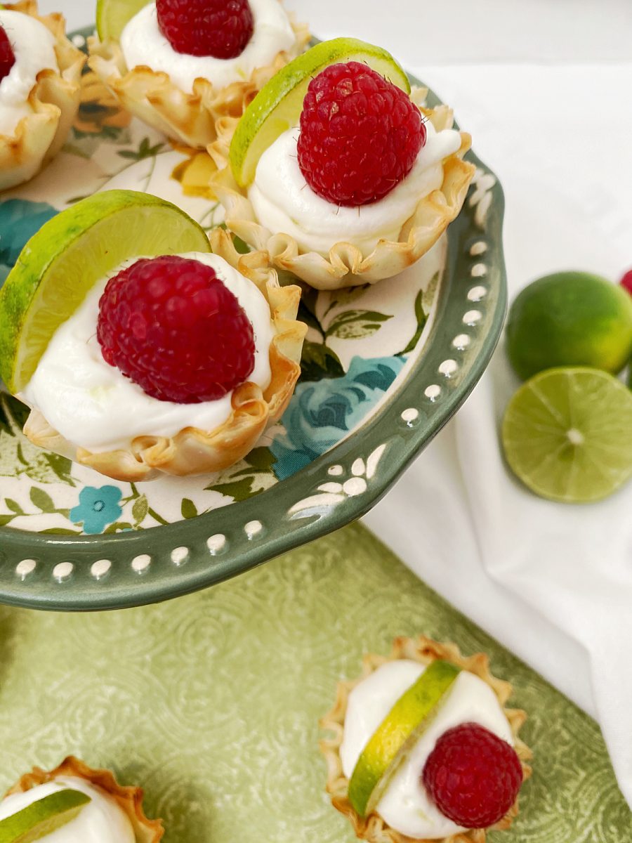 close up of mini tarts with raspberry garnish - updated