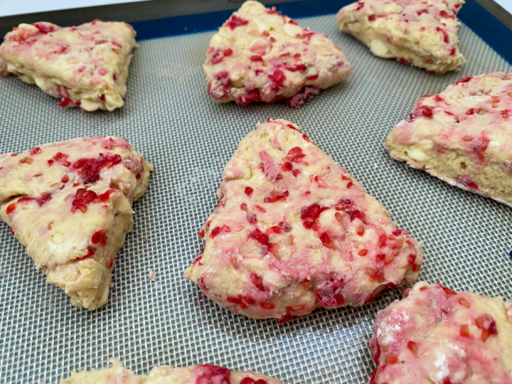 close up of raspberry scone dough on baking sheet
