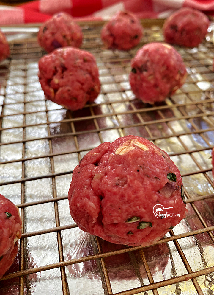 homemade meatballs on baking sheet ready to bake