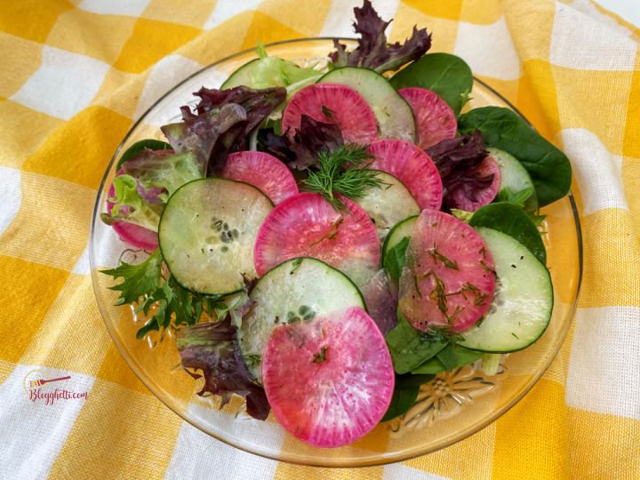 salad plate with cucumber radish and greens with homemade dill dressing