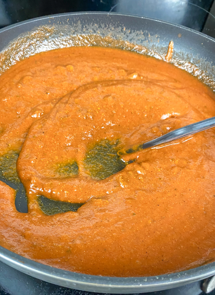 Enchilada sauce simmering in skillet