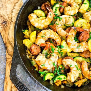 Sausage and shrimp with summer vegetables in cast iron skillet