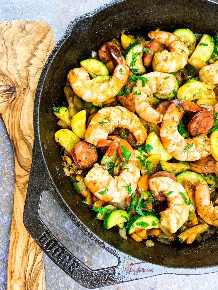 Sausage and shrimp with summer vegetables in cast iron skillet