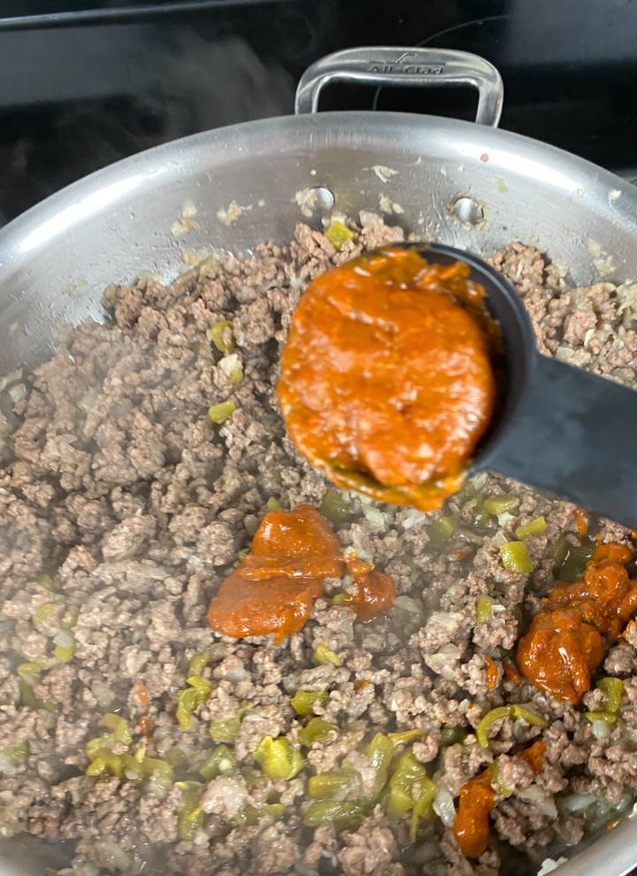 meat filling for beef enchiladas simmering in skillet
