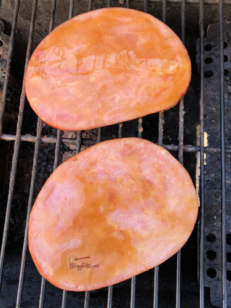 ham steaks on grill with glaze