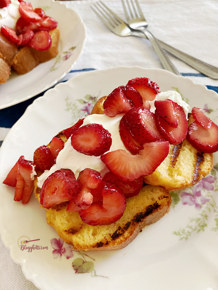 sliced grilled strawberry shortcake on white plate