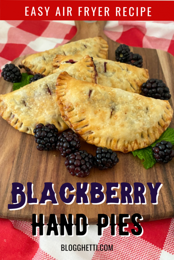 air fried blackberry hand pies on wooden tray with fresh blackberries and mint leaves for garnish
