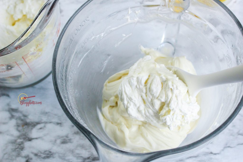 folding in the whipped cream into the cream cheese mixture