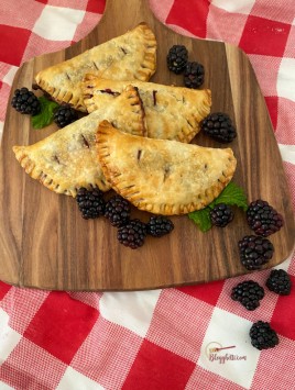 mini blackberry hand pies on wooden board