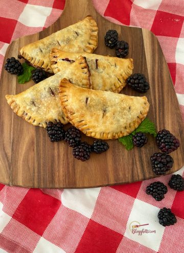 mini blackberry hand pies on wooden board