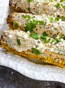 Mexican Street Corn platter with toppings next to it