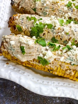 Mexican Street Corn platter with toppings next to it