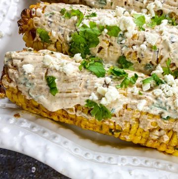 Mexican Street Corn platter with toppings next to it