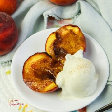 air fryer grilled peaches with scoop of ice cream on white plate