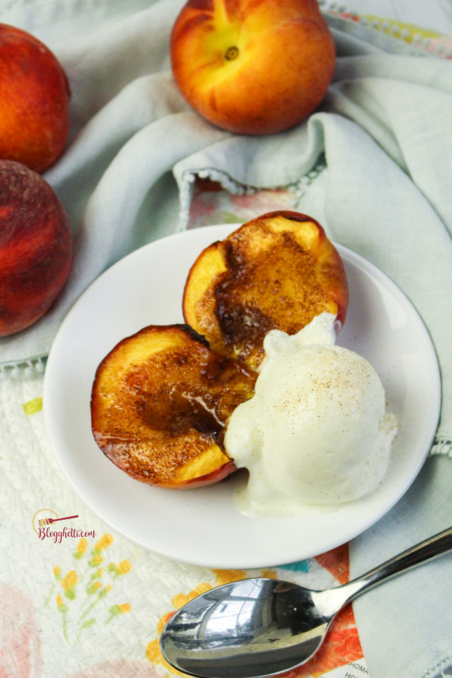 air fryer grilled peaches with scoop of ice cream on white plate