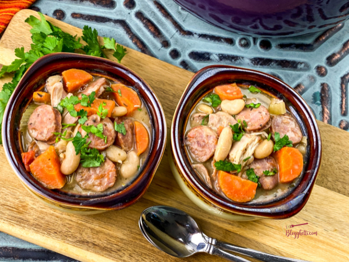 chicken and sausage white bean stew in two ceramic bowls