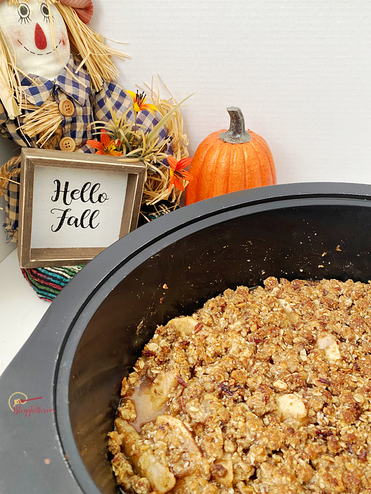slow cooker apple pear crisp with Hello Fall sign in background
