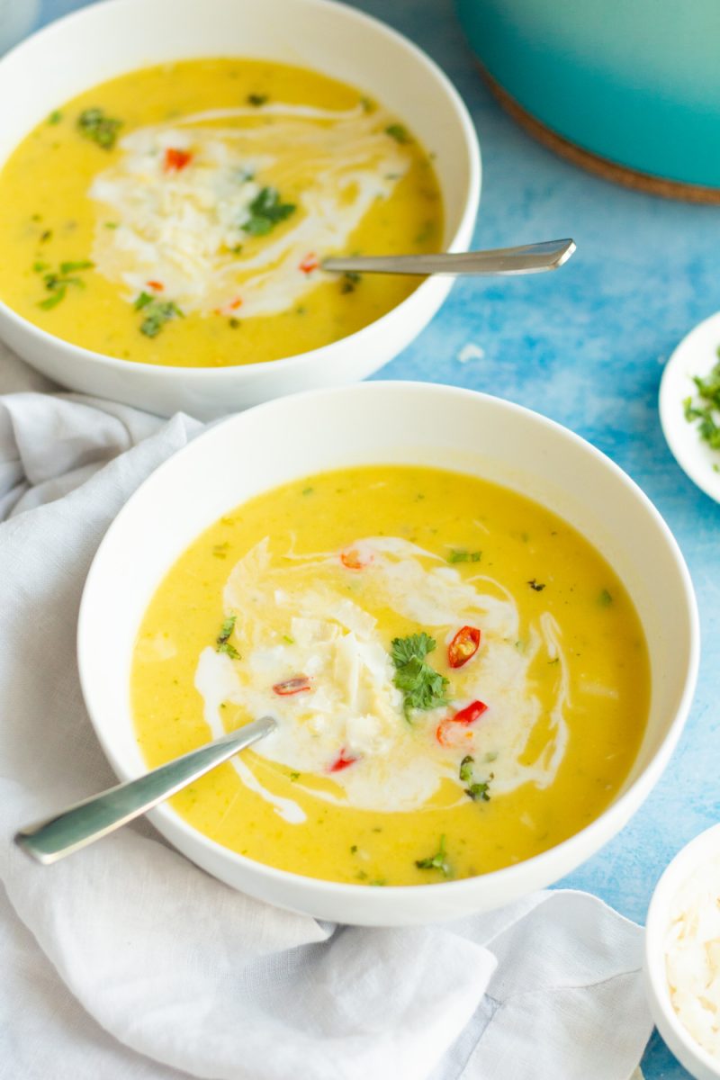 two white bowls with autumn squash soup