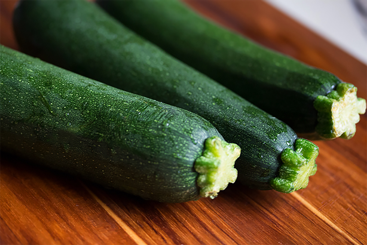 fresh zucchini on wooden board