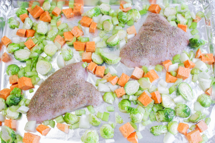Turkey Breast Tenderloin and vegetables on sheet pan ready to roast